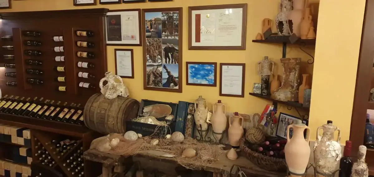 A wall of framed articles and awards in the Edivo cellar
