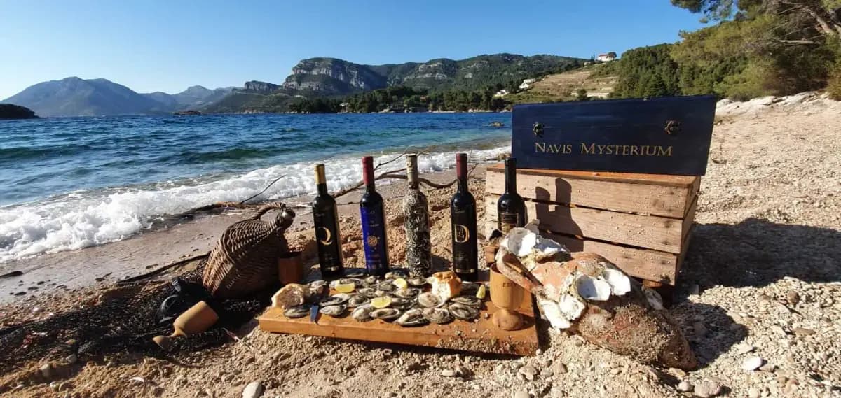 Bottles on a table by the sea, with the peninsula behind